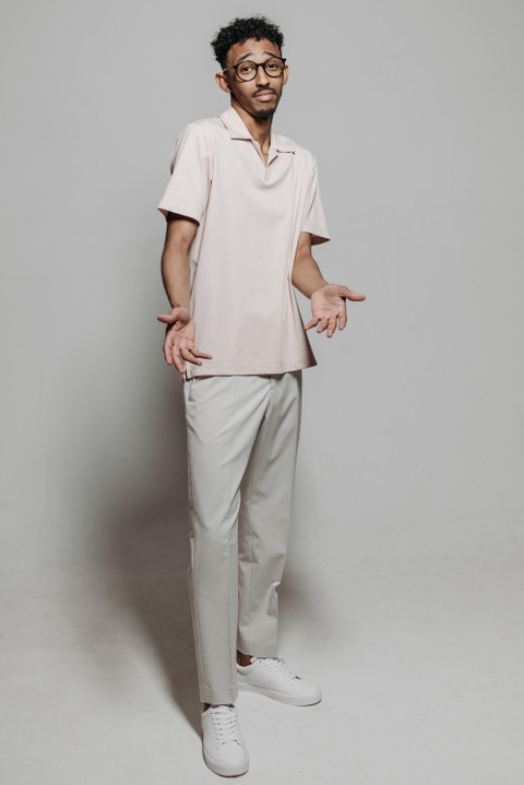 A cream camp-collar shirt with matching trousers.