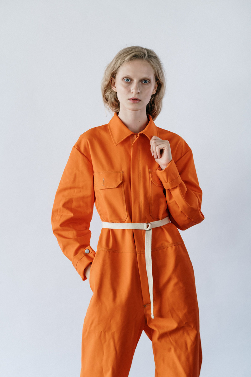 An orange belted utility jumpsuit.