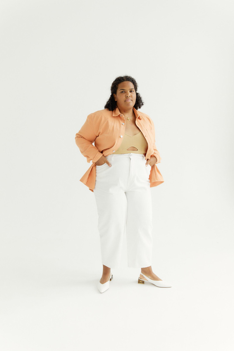 White wide-leg trousers with a peach shirt.
