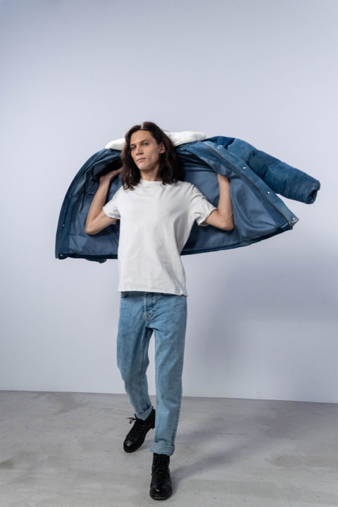 A mid-blue denim trucker jacket over a white tee.