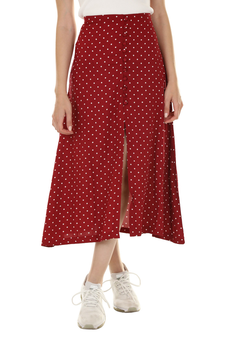 A red polka-dot midi skirt with a slit.