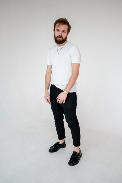 A white crew tee with black trousers.