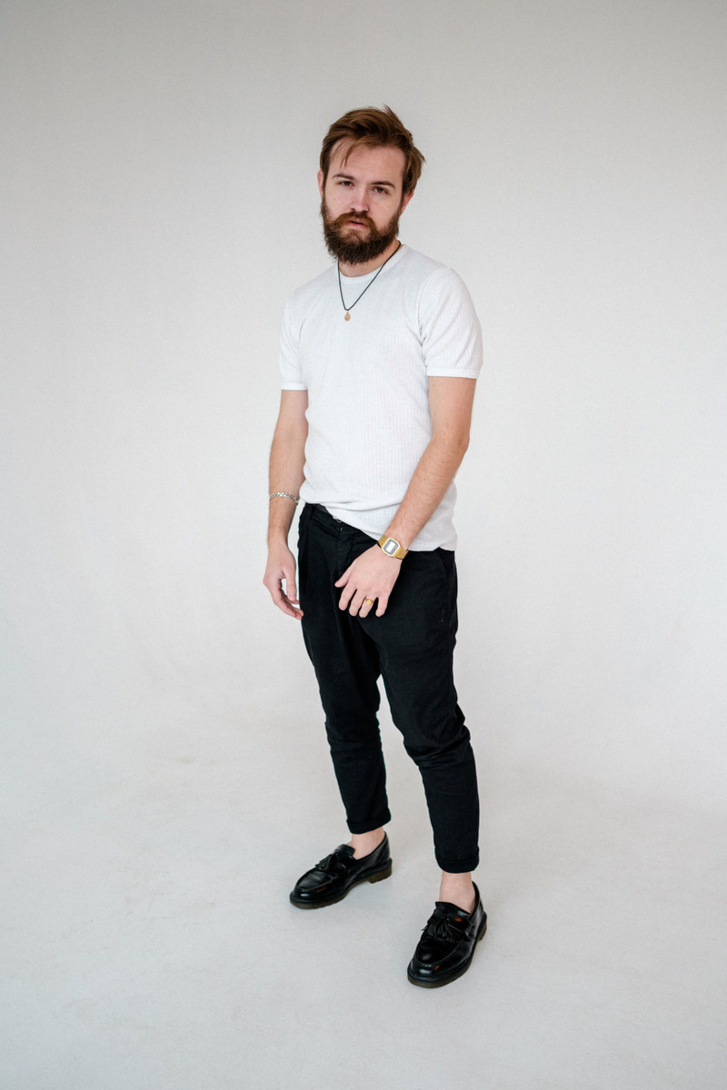 A white crew tee with black trousers.