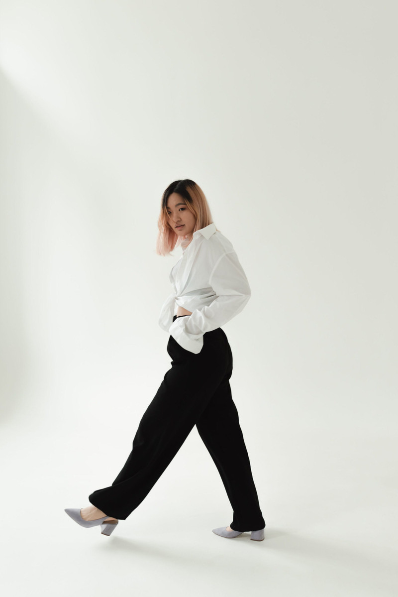 A white poplin shirt with black wide trousers.